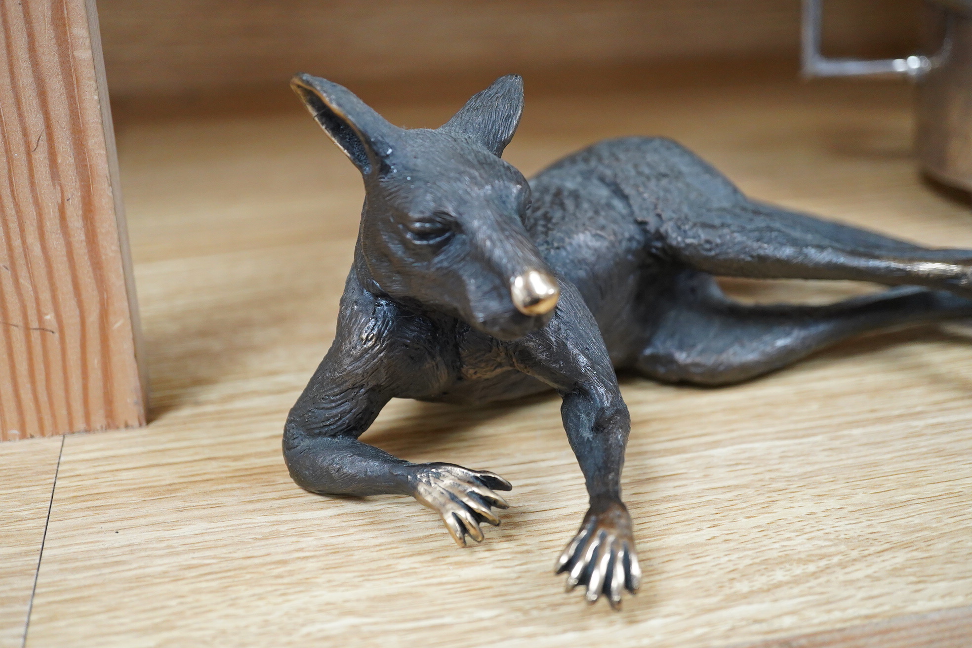A late 20th century Australian partially gilt bronze model of a recumbent kangaroo, limited edition 5/50, 26cm wide